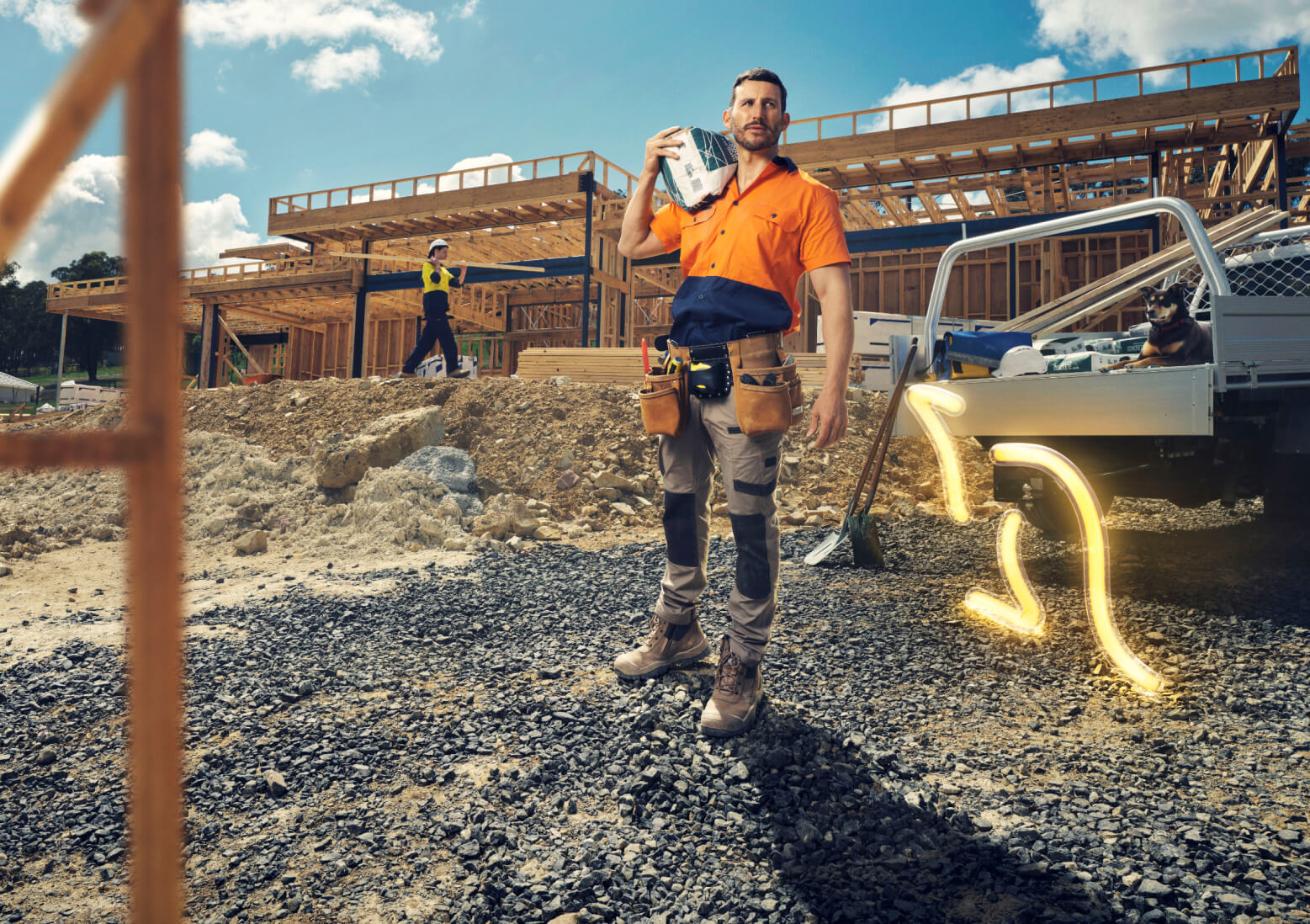 A construction worker on a job site with a glowing neon kangaroo jumping behind a silver work truck.