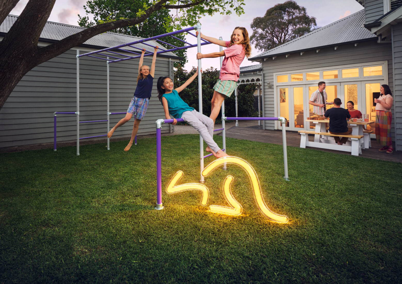 Australian backyard with kids on monkey bars and a glowing neon kangaroo light trail.